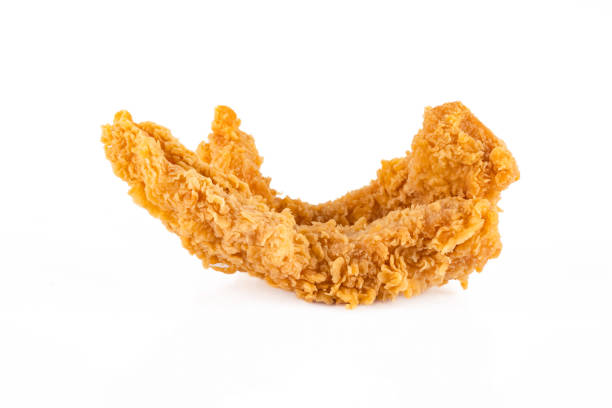 Stack of fried chicken pieces. Chicken strips isolated on white background.