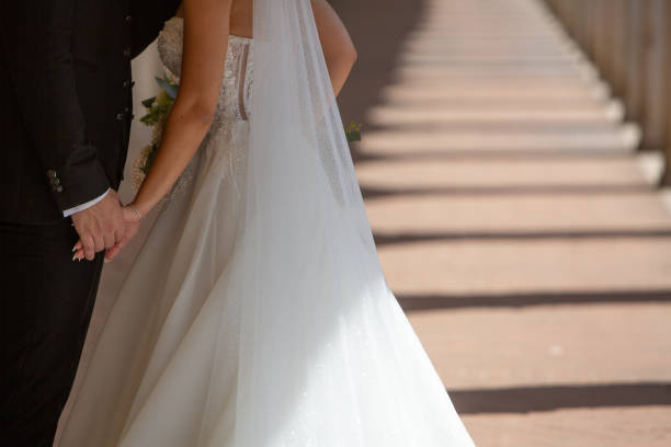 Newlywed couple holding hands, walking down the aisle after their wedding ceremony, starting their new life together