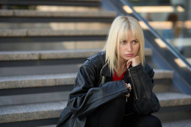 Young ukrainian model sitting pensively on steps