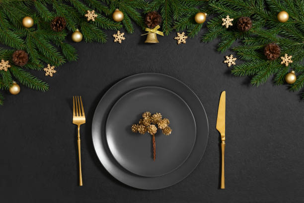 istock Christmas table setting with gold cutlery and festive decoration on black background. View from above. New Year serving. 2188323189