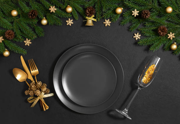 istock Black table setting with empty plate, gold cutlery, festive accessories and fir branches for Christmas dinner. Top view, flat lay. 2188324003
