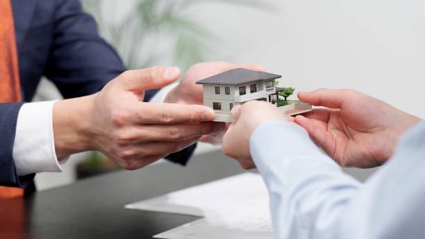 Hands of a businessman selling real estate stock photo