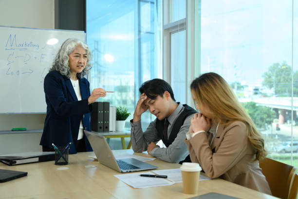 istock Angry senior team leader scolding office workers during a meeting 2188327170