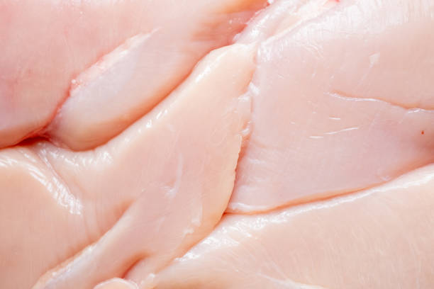 Raw Chicken breast with parsley on a  dish on white background