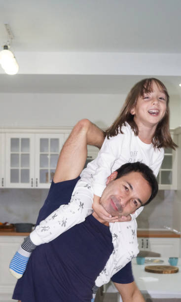 istock Dad carries his daughter on his back and having fun 2188330243