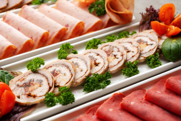 Platter of fresh meat cold cuts on table, close up