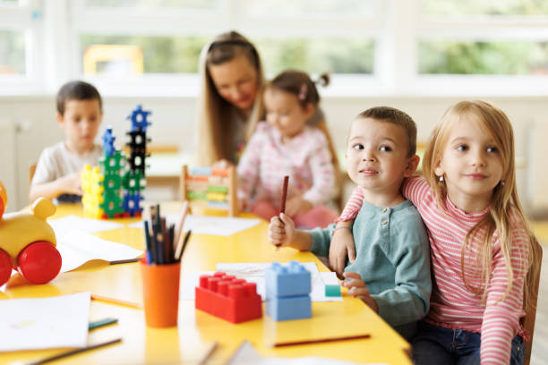 istock Children drawing and playing whit their kindergarten teacher 2188332014