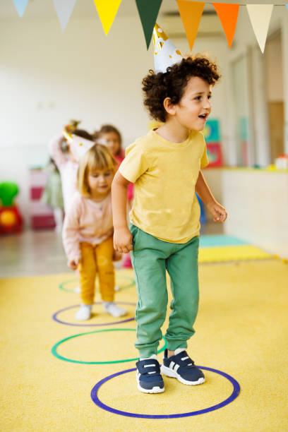 istock Kids jumping through hoops at a birthday party 2188332380