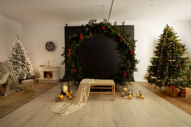 istock Cozy Christmas interior with decorated trees, wreaths, candles, and a bench 2188333699