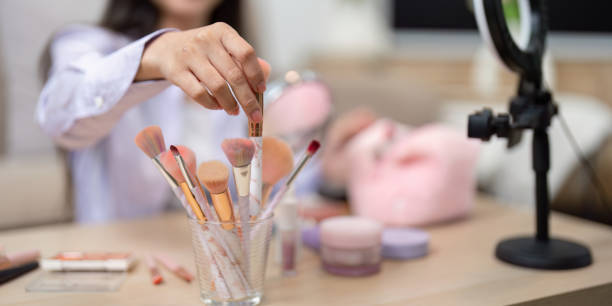istock Asian woman selecting makeup brush from collection on table 2188335844
