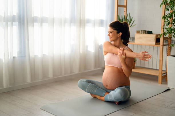 istock Active pregnant woman practicing yoga stretching muscles on mat, doing prenatal exercises for health 2188335874