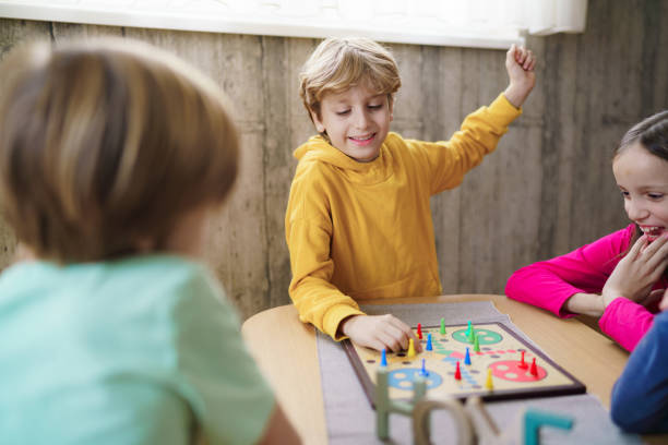 istock Kids playing Ludo game at home 2188337425