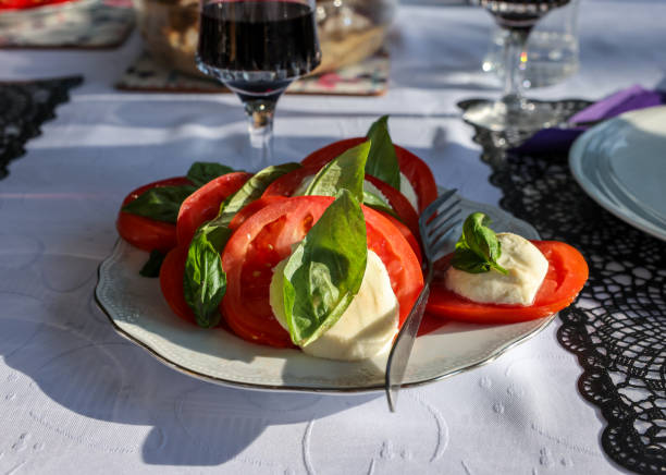 istock Tasty mozzarella cheese with basil and tomatoes on white plate 2188337846