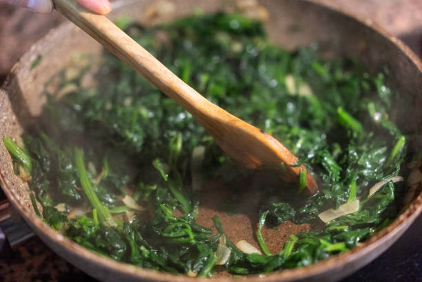 istock Spinach,garlic and onion sauteed in a frying pan, 2188338970