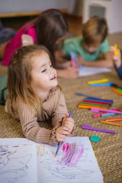 istock Little girl coloring with crayons at home 2188339064