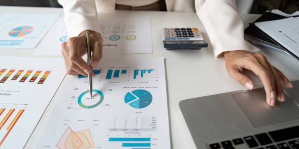 istock Professional Business Analysis Meeting with Charts, Graphs, and Laptop in Modern Office Setting 2188339506
