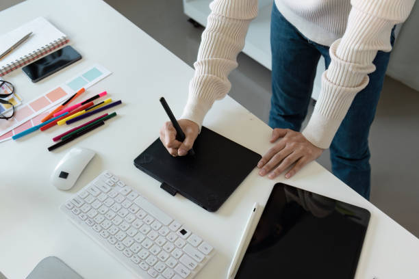 istock Creative Graphic Designer Working with Digital Tablet and Color Swatches in Modern Office Environment 2188339619