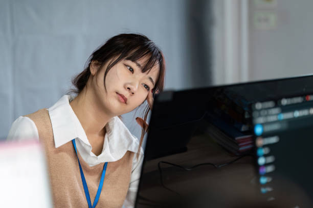 istock Stressed Office Worker Experiencing Office Syndrome at Desk in Modern Workplace Environment 2188340259