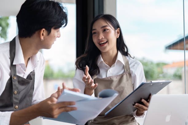 istock Young Entrepreneurs Collaborating in Modern Office Environment with Laptops and Documents for Innovative Startup Business Planning 2188340429