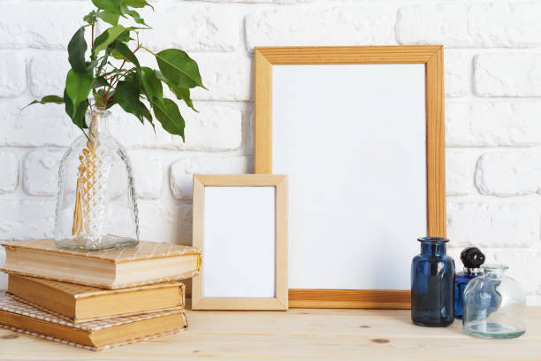 istock Wooden frame mockup on table with modern vase and books 2188340746