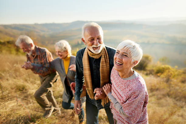 istock Happy senior couples talking in autumn day on a hill. 2188340747
