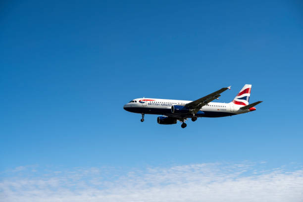 23.08.2024 London, UK. A British Airways plane nears its destination under a vast, clear blue sky, its bold red, white, and blue livery standing out as it glides gracefully through the serene airspace.