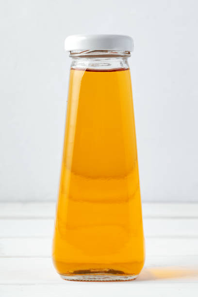 istock Small glass bottle of fresh juice on white background 2188341073