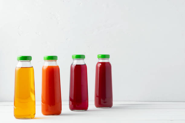 istock Glass bottles of different juices on white background 2188341074