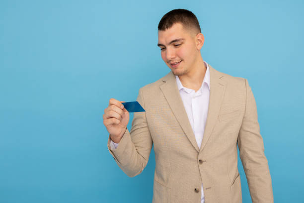istock Young businessman holding a credit card confidently 2188344744