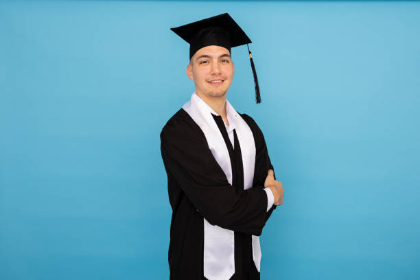 istock Young male student in graduation gown smiling 2188346057