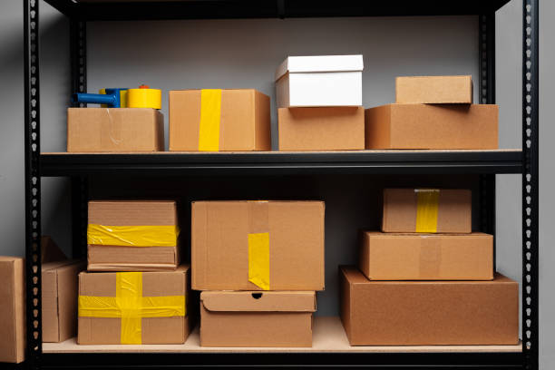 istock Rack shelves with paper boxes in warehouse. 2188346493