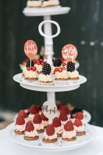 istock Chocolate Cupcakes with Fresh Berries on White Tiered Stand 2188347390