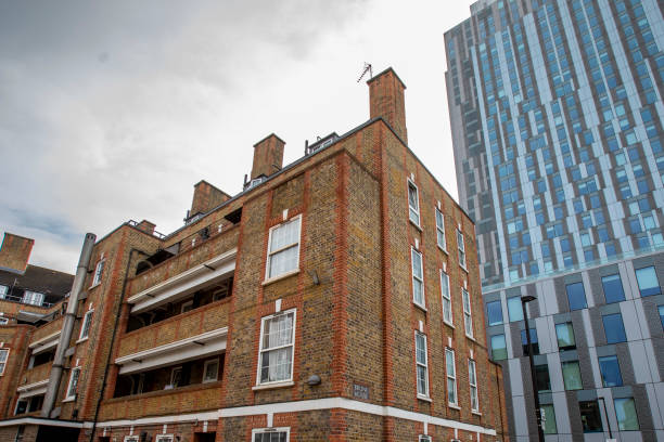 istock Old East London building with a modern office building behind 2188348096