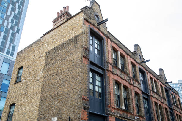 istock Old East London building with a modern office building behind 2188348103