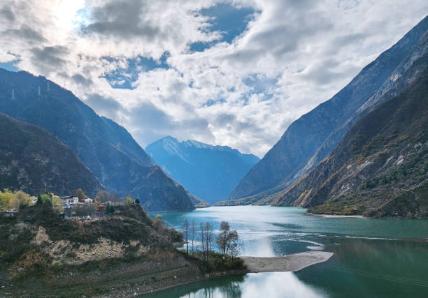 istock Lake with cloudy sky, trees and mountain with snow. 2188348292