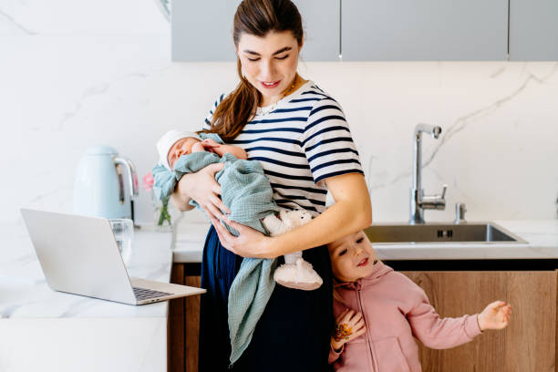 istock Mother balancing work and family in modern kitchen interior. 2188349454