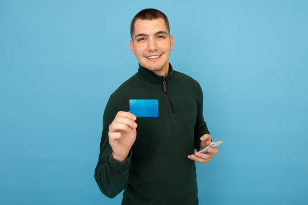 istock Confident entrepreneur holding a credit card and smartphone 2188349733
