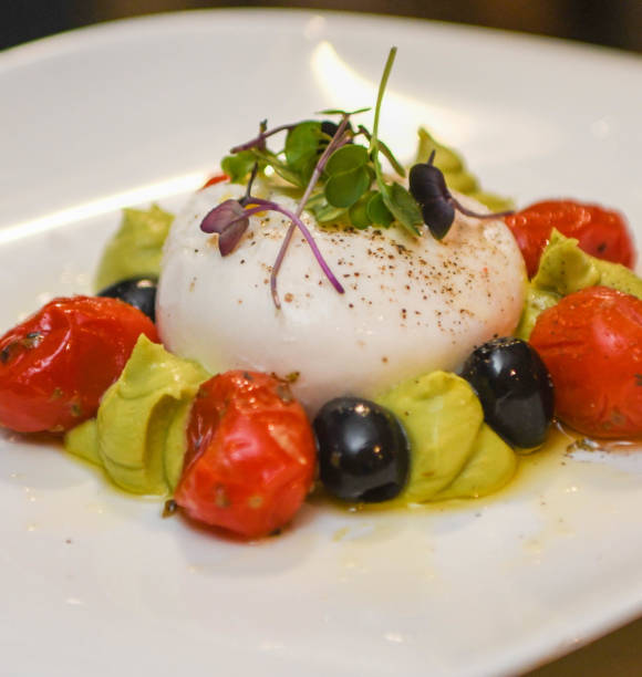 istock Caprese salad with mozzarella cheese, olives and tomato 2188350120