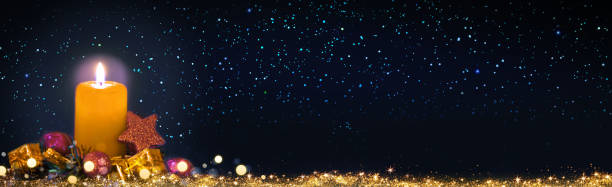 istock Golden Advent candle isolated on stars sky background . 2188350423