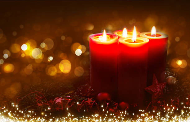 istock Four burning Advent candles isolated on blurred bokeh background. 2188350541