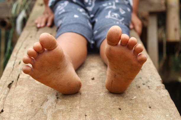 istock little boy's feet playing on a wooden board 2188350606