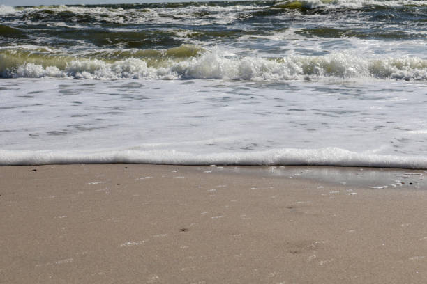 istock Gentle Ocean Waves Washing Over Sandy Beach 2188352940