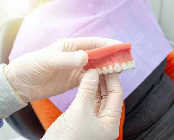 istock Dentist holding teeth model with braces in dental clinic 2188353650