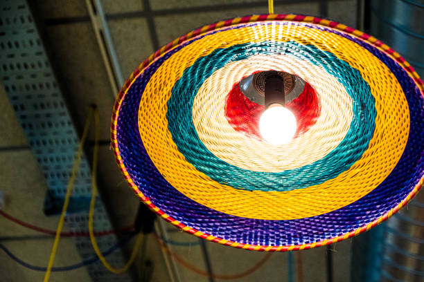 Handwoven basket lampshade casts a light, enhancing the industrial space with artistry and creativity. This unique design showcases vibrant craftsmanship and adds a modern touch to interior decor