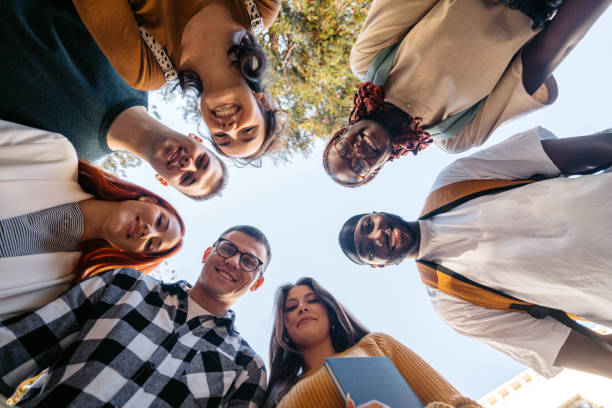 istock Group Of Students Looking Down At The Camera On The University Campus 2188356766