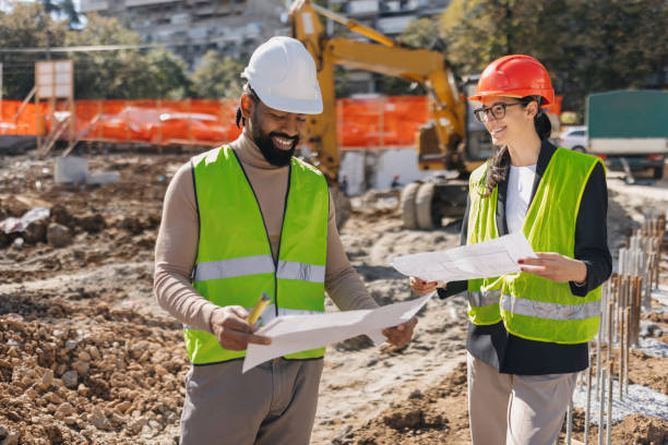 istock Happy engineers discussing construction project outdoors 2188359093