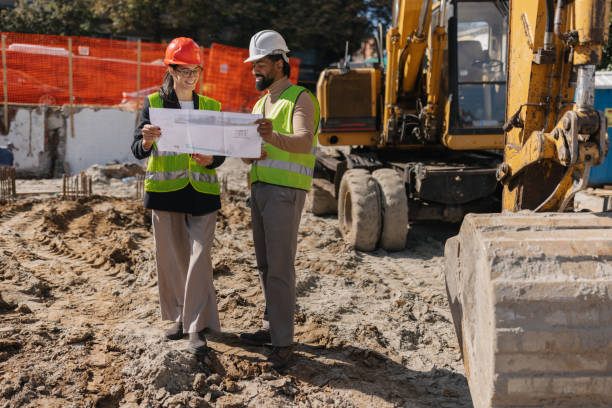 istock Colleagues Reviewing Plans at Construction Site 2188359274
