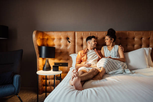 istock Couple on vacation in hotel bed 2188360284