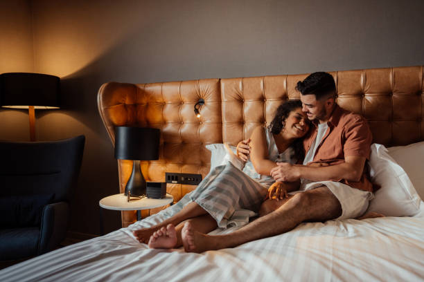 istock Couple on vacation in hotel bed 2188361442