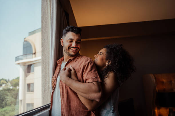 istock Couple in hotel room window 2188361491